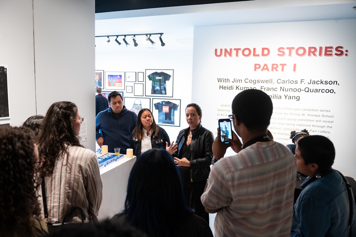 Emilia Yang discusses her work with visitors at the Untold Stories: Part I opening reception.
