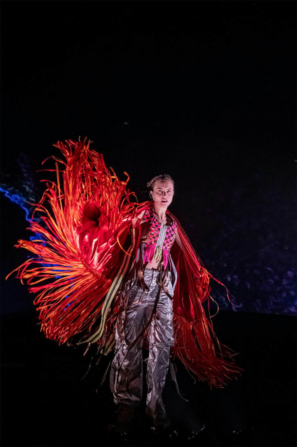 A woman performs in a red costume.