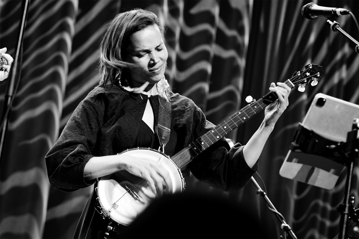 Rhiannon Giddens playing a banjo onstage