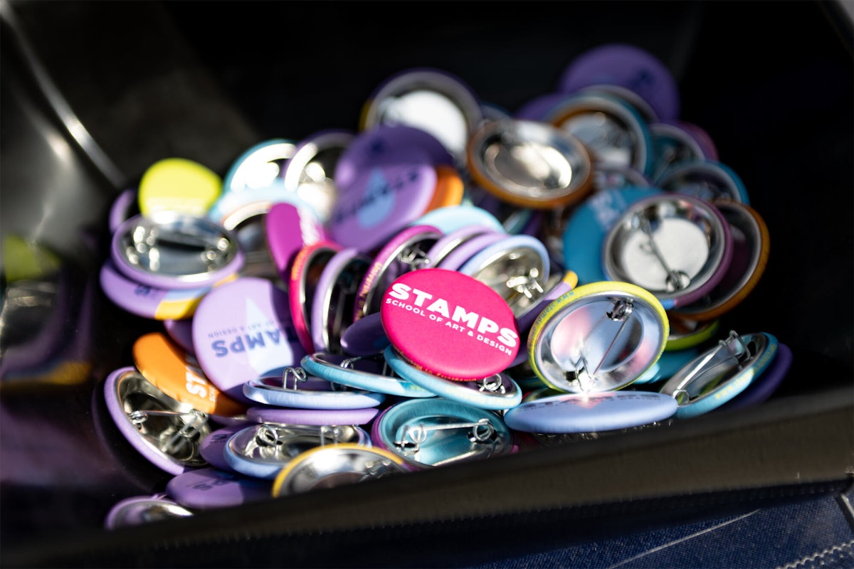 A bin of colorful STAMPS pins