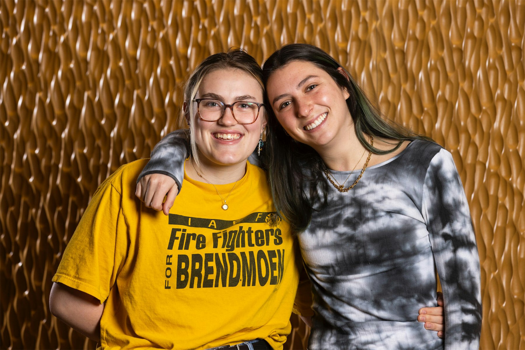 Maggie Wiebe (left), in a yellow shirt and glasses, and Jessie Rice (right), in a tie-dyed shirt