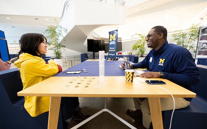 A student sits across the table from a recruiter