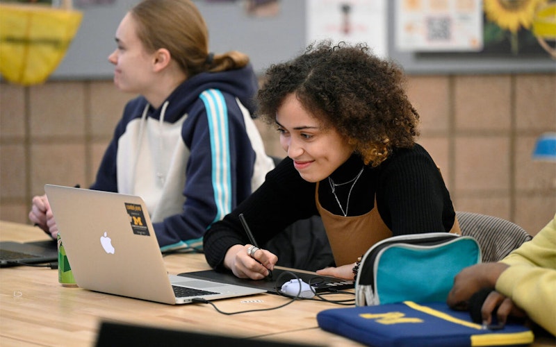 a student listens to a reviewer at Portfolio Prep