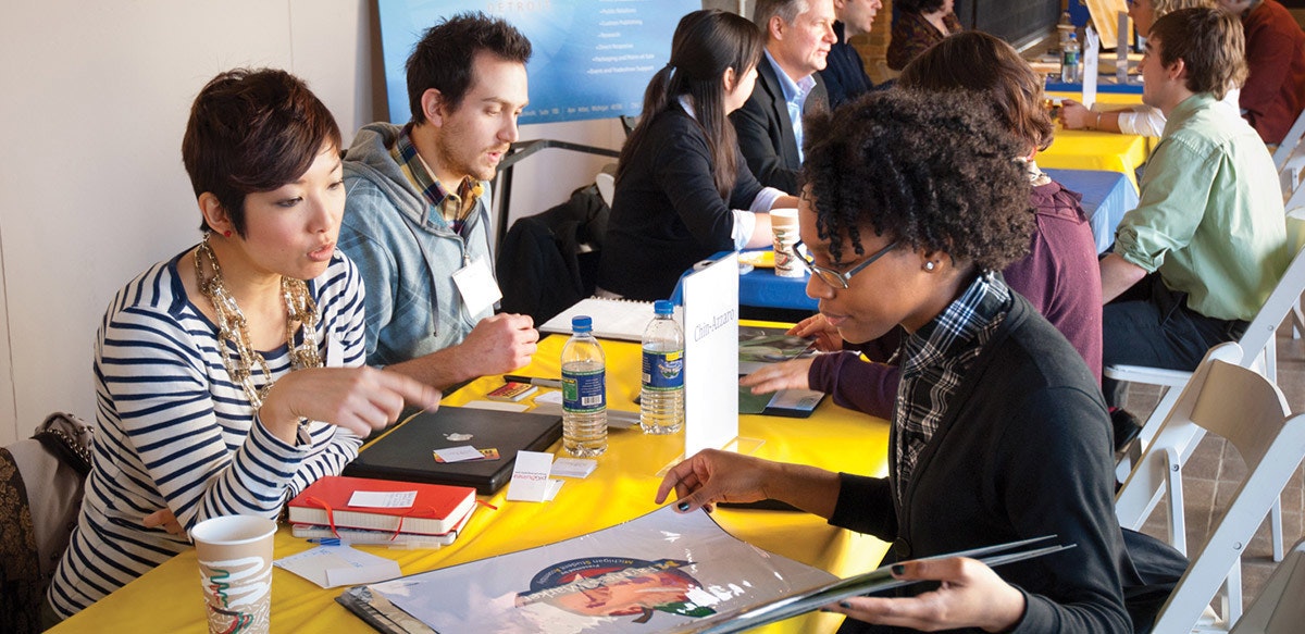 Yen Azzarro reviews a student porfolio at a Portfolio Prep event